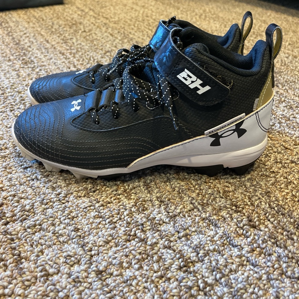 White black and gold baseball cleats